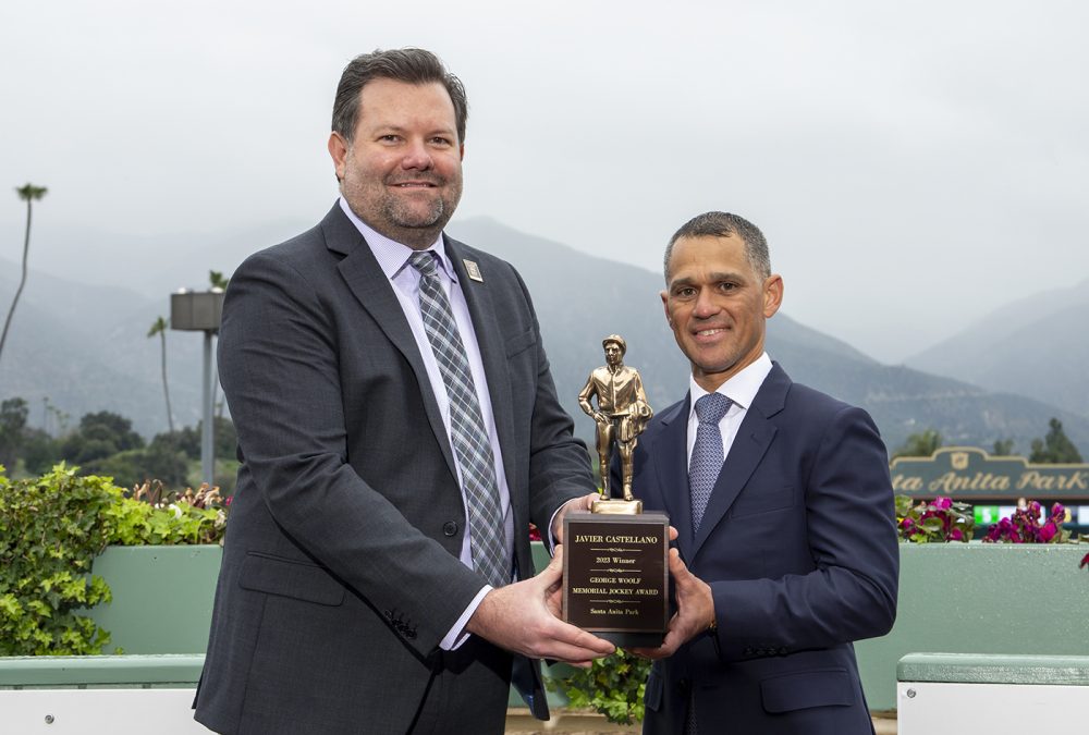 Javier Castellano,, right, a four-time Eclipse Award winning jockey and member of racing’s Hall of Fame, was accompanied by friends, family members and a number of fellow riders on Sunday, March 19, 2023 at Santa Anita Park, Arcadia, CA, as he accepted the prestigious George Woolf Memorial Jockey Award Trophy from the track's Senior Vice President and General Manager Nate Newby, left, in a Runhappy Winner’s Circle ceremony..              The Woolf Award has been presented annually by Santa Anita since 1950. The winner is determined by a vote of jockey’s nationwide and is named for one of the greatest big money riders of his era. Other finalists this year were jockeys Daniel Centeno, Terry Houghton, Edwin Maldonado and Willie Martinez.             Entering Thursday, the 45-year-old Castellano had ridden 5,624 winners and banked more than $378 million in purse earnings, which is second all-time behind only John Velazquez ($463 million). Benoit Photo